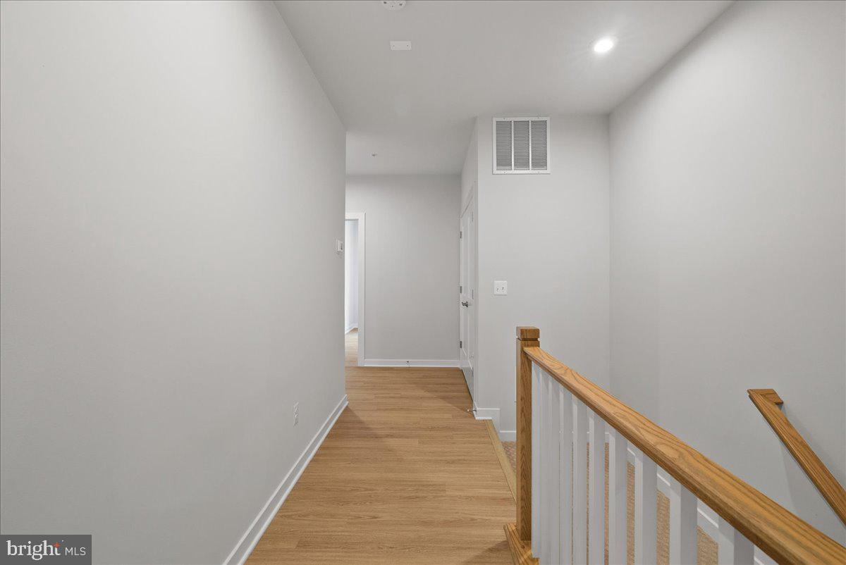 4128 Legato Road, Unit 53 Fairfax, VA 22033 - Photo 15 of 39 a view of a hallway with wooden floor and staircase