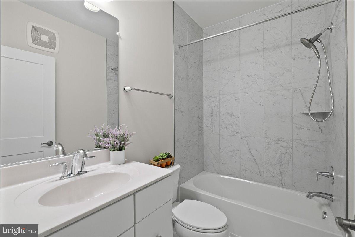 4128 Legato Road, Unit 53 Fairfax, VA 22033 - Photo 17 of 39 a bathroom with a sink toilet tub and shower