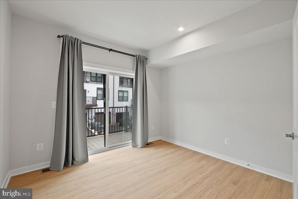 4128 Legato Road, Unit 53 Fairfax, VA 22033 - Photo 20 of 39 an empty room with wooden floor and a hallway
