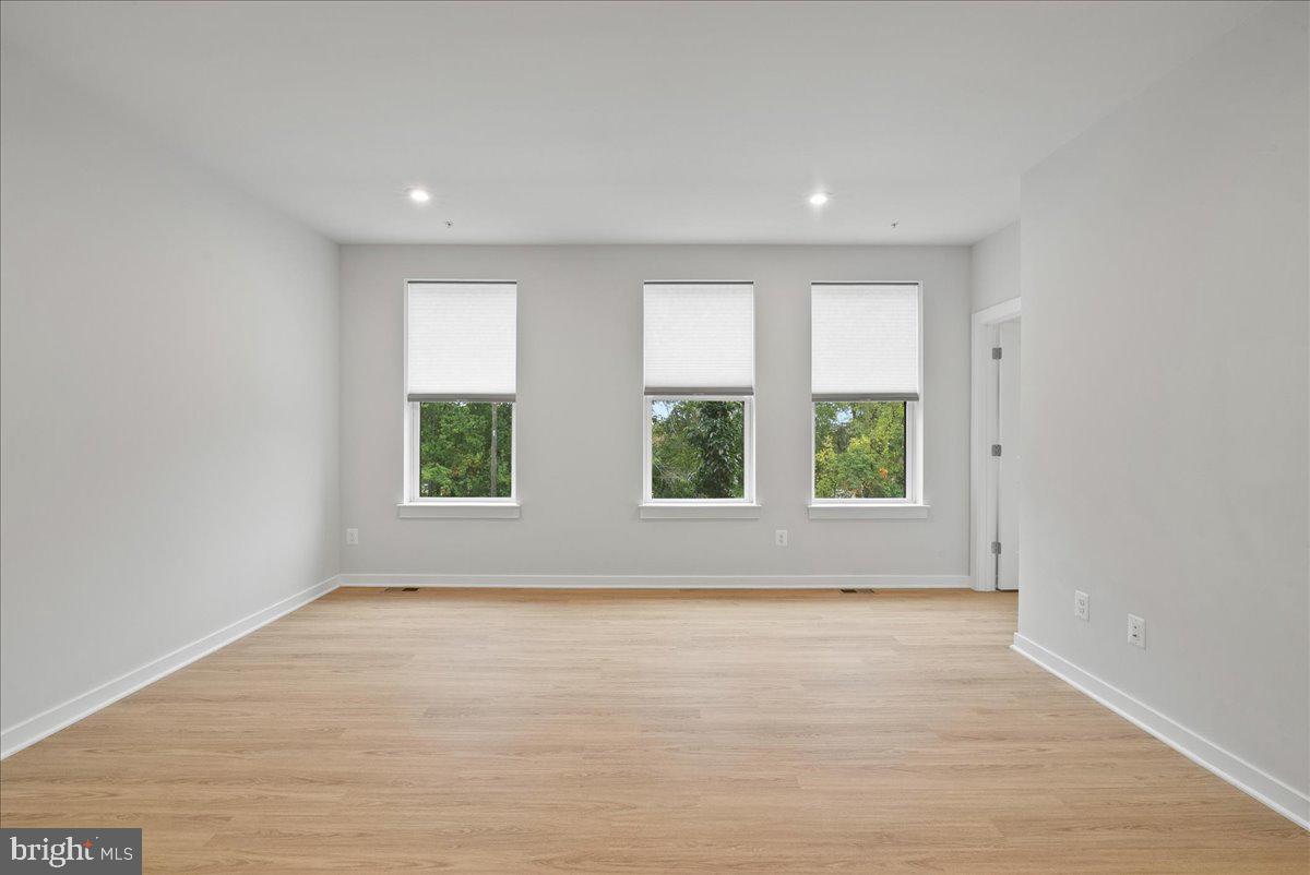 4128 Legato Road, Unit 53 Fairfax, VA 22033 - Photo 26 of 39 an empty room with wooden floor and windows
