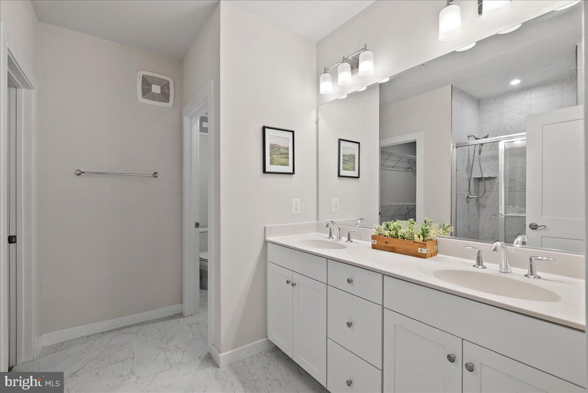 4128 Legato Road, Unit 53 Fairfax, VA 22033 - Photo 30 of 39 a bathroom with double sink and a mirror