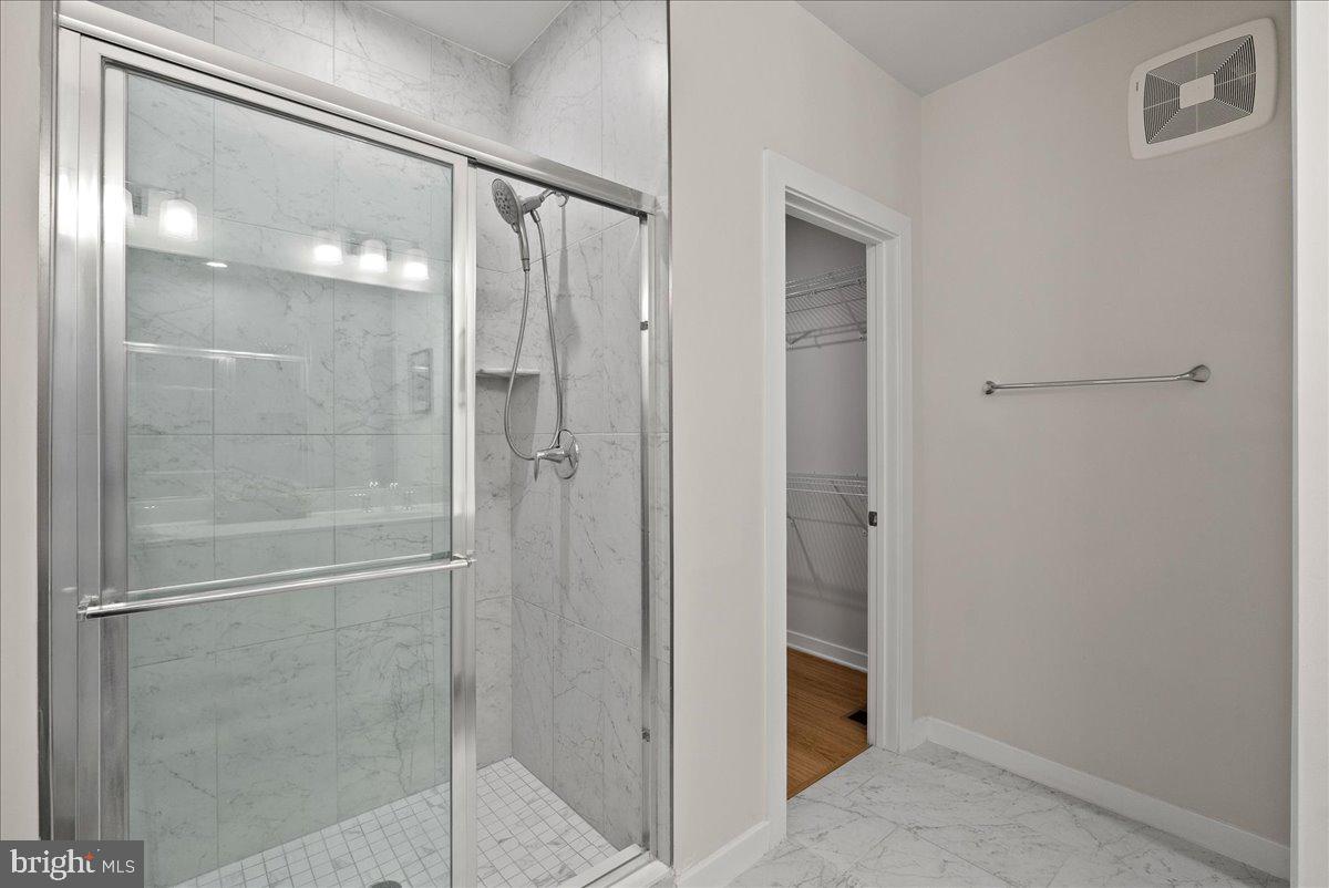4128 Legato Road, Unit 53 Fairfax, VA 22033 - Photo 31 of 39 a bathroom with a glass shower door