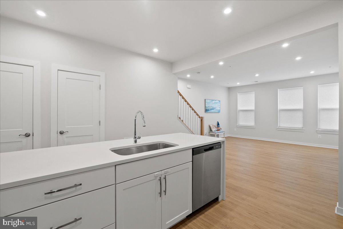 4128 Legato Road, Unit 53 Fairfax, VA 22033 - Photo 7 of 39 a hallway with sink and mirror