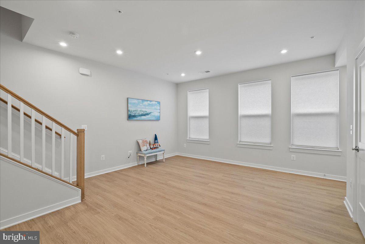 4128 Legato Road, Unit 53 Fairfax, VA 22033 - Photo 9 of 39 an empty room with wooden floor and windows