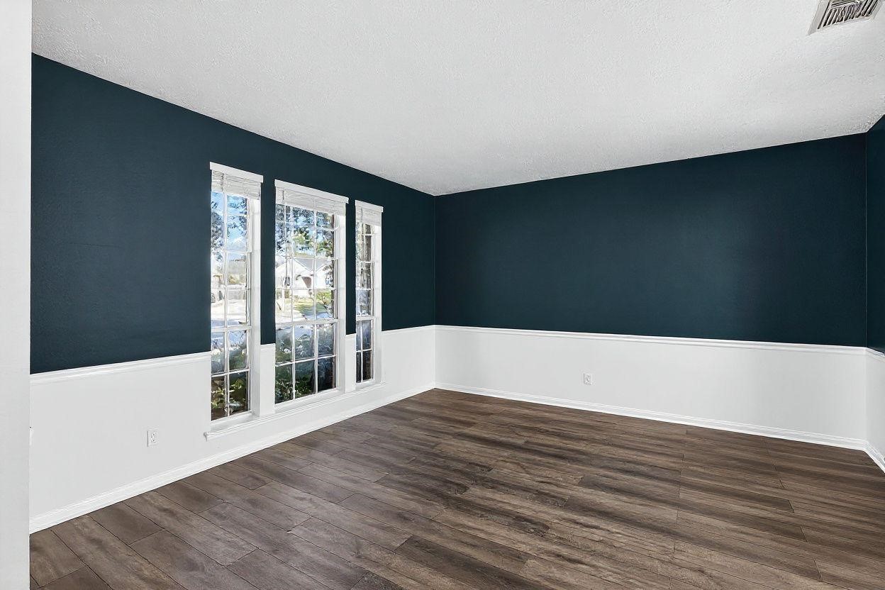 7622 McCormick Mill Court Houston, TX 77095 - Photo 19 of 40 a view of an empty room with wooden floor and a window