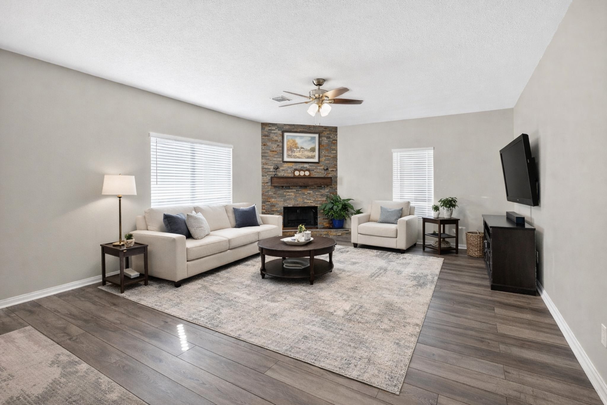 7622 McCormick Mill Court Houston, TX 77095 - Photo 23 of 40 a living room with furniture a fireplace and a flat screen tv