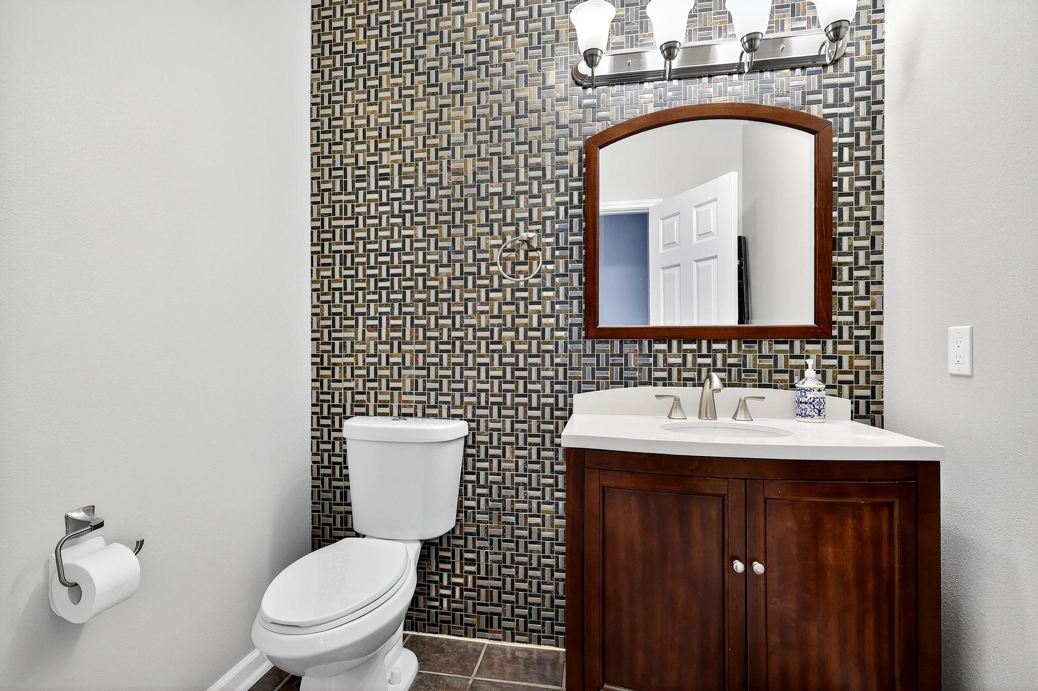 7622 McCormick Mill Court Houston, TX 77095 - Photo 24 of 40 a bathroom with a toilet sink vanity and mirror