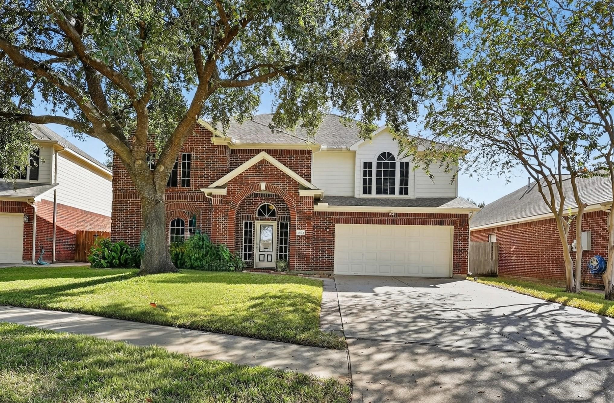 7622 McCormick Mill Court Houston, TX 77095 - Photo 4 of 40 a front view of a house with a yard and garage