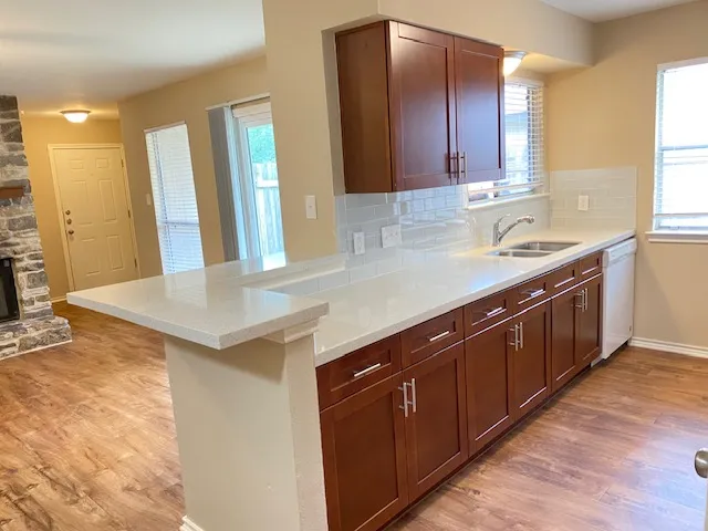 a kitchen with a sink and wooden cabinets