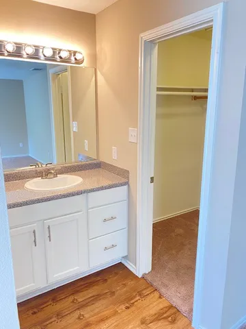 a bathroom with a granite countertop sink and a mirror
