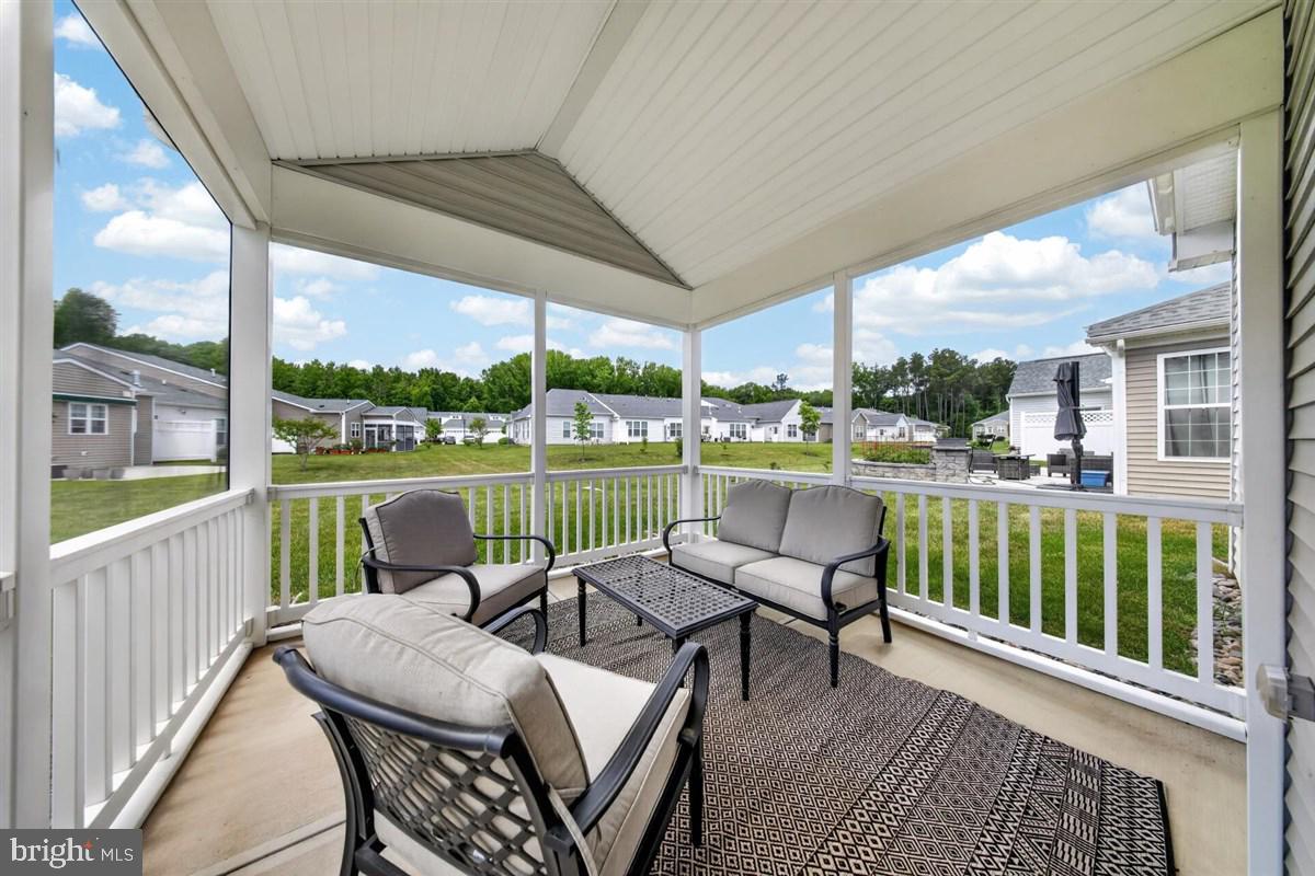 1426 Whispering Woods Road Middletown, DE 19709 - Photo 28 of 37 a view of a chair and tables in the balcony