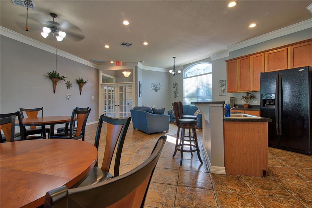1900 Scofield Ridge Parkway, Unit 5501 Austin, TX 78727 - Photo 21 of 21 An open floorplan seamlessly connects the kitchen and living areas, bathed in natural light from broad windows.