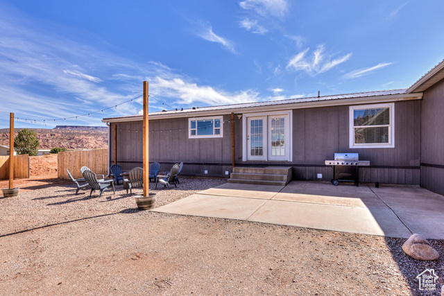 33 Merriam Court Moab, UT 84532 - Photo 49 of 56 Back patio with grill, firepit and seating, and outdoor lights