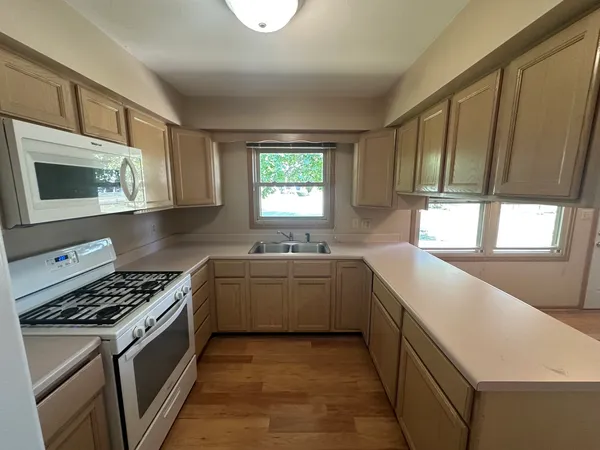a kitchen with stainless steel appliances a stove sink and cabinets