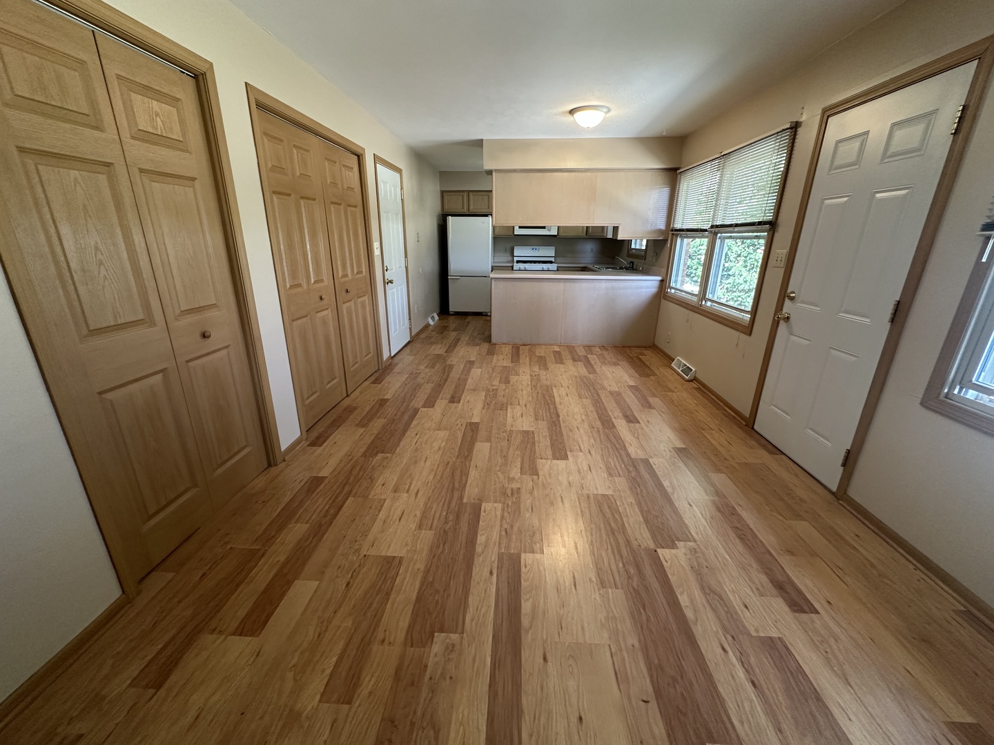 907 A Carlisle Drive Rochelle, IL 61068 - Photo 5 of 10 a view of a kitchen with wooden floor and electronic appliances