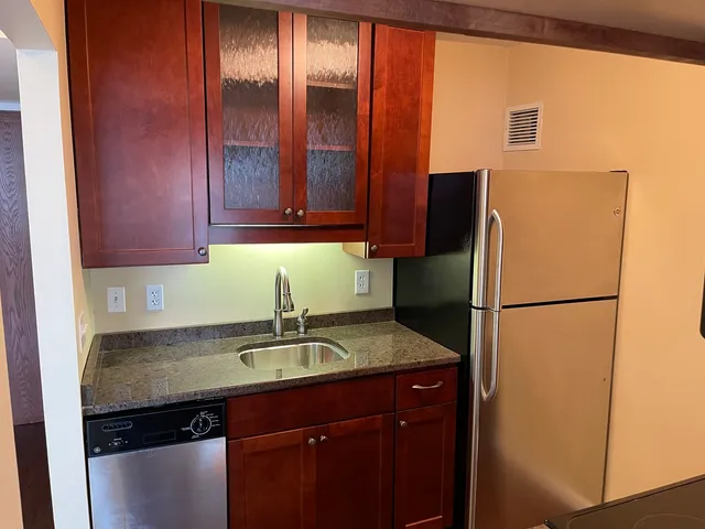 a kitchen with a refrigerator and a sink