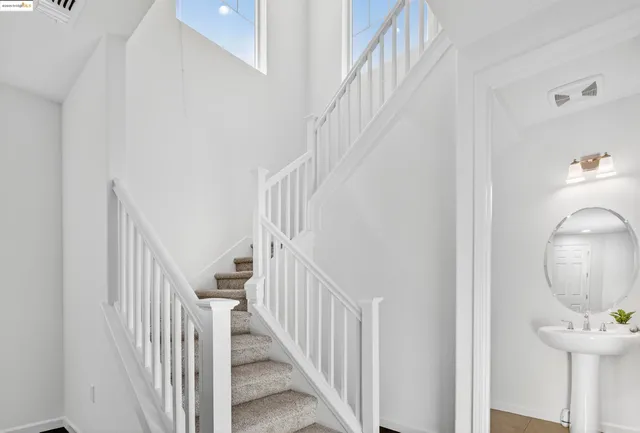 a view of staircase with railing and a painting