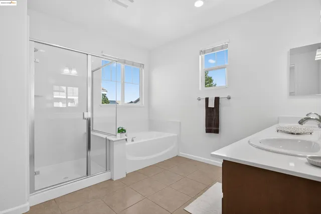 a bathroom with a sink a bathtub and a mirror