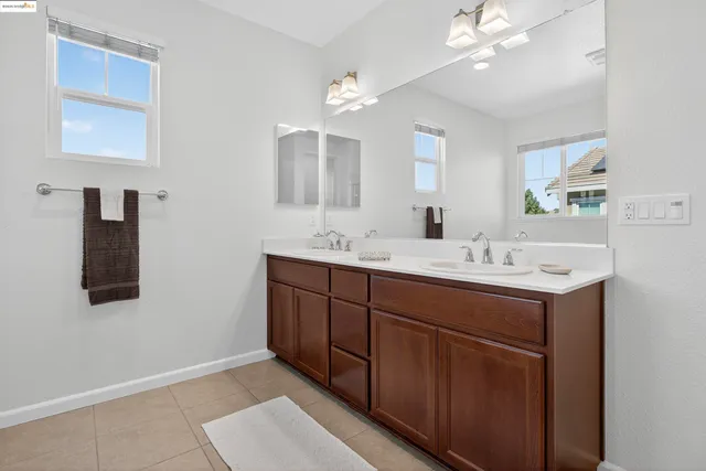a bathroom with a sink double vanity and a mirror