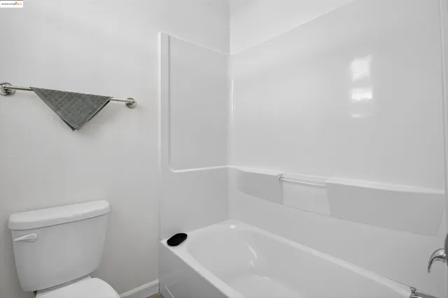 a bathroom with a toilet and a bathtub