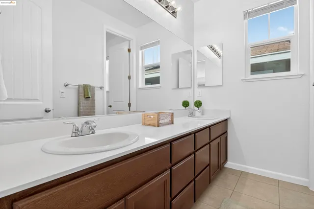 a bathroom with a sink double vanity and a mirror