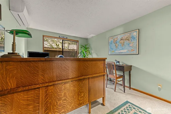 a living room with furniture a flat screen tv and a table