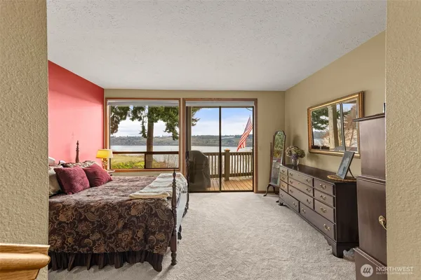 a bedroom with a bed and large window