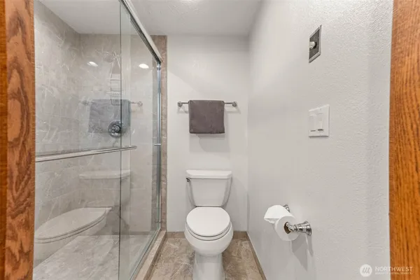 a view of a balcony with chairs and wooden floor