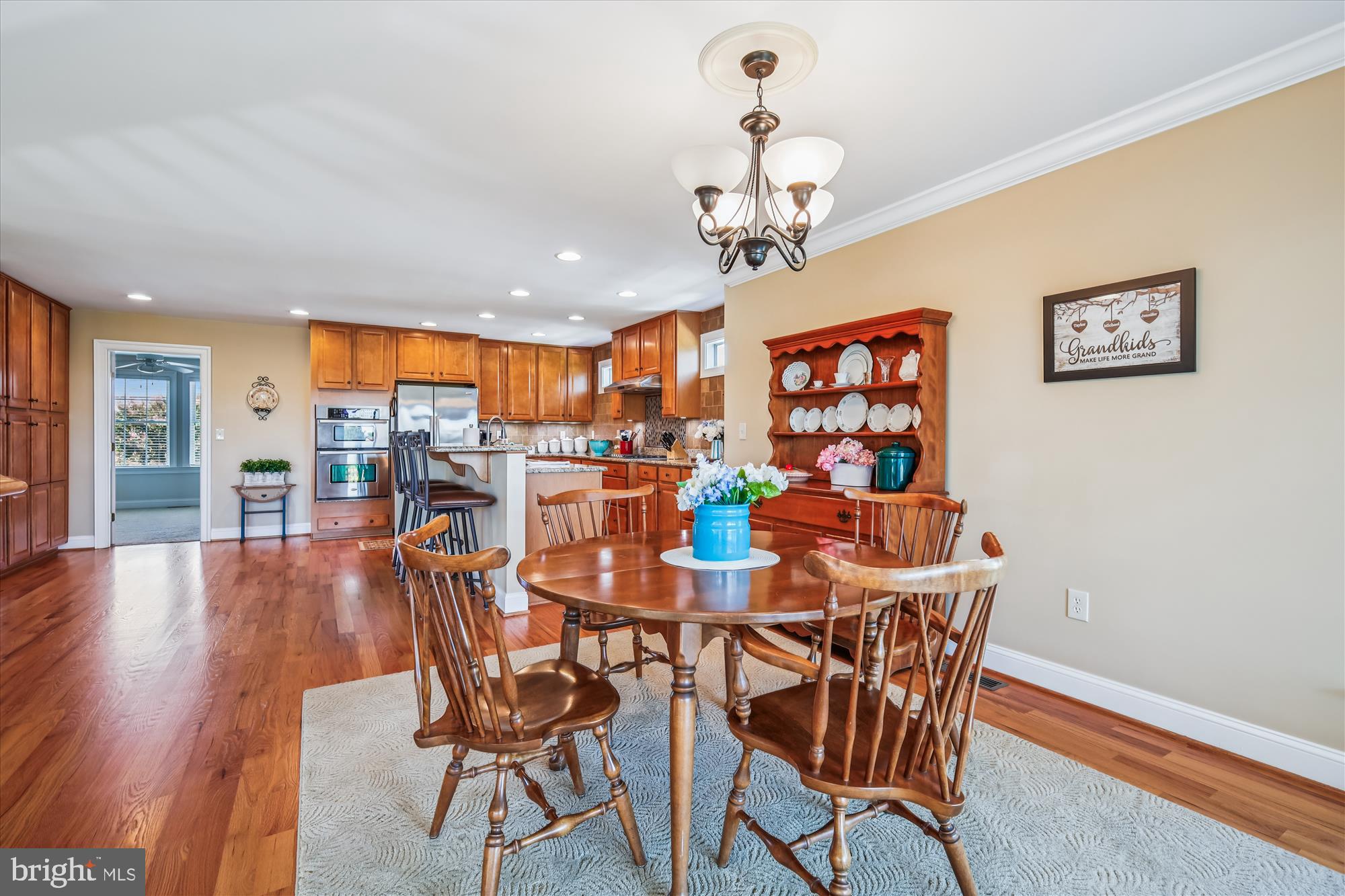 635 Dominion Road Chester, MD 21619 - Photo 24 of 50 a view of a dining room with furniture wooden floor and chandelier