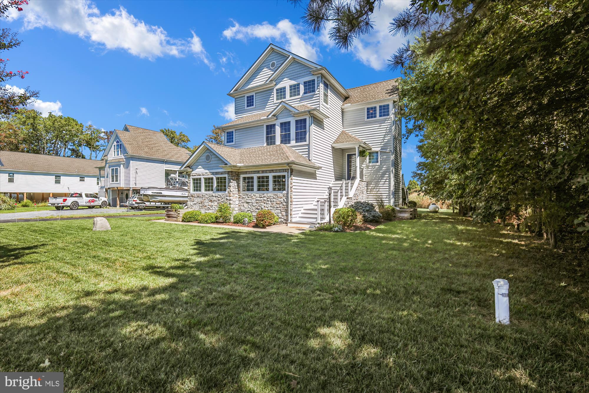635 Dominion Road Chester, MD 21619 - Photo 3 of 50 a front view of a house with a yard table and chairs