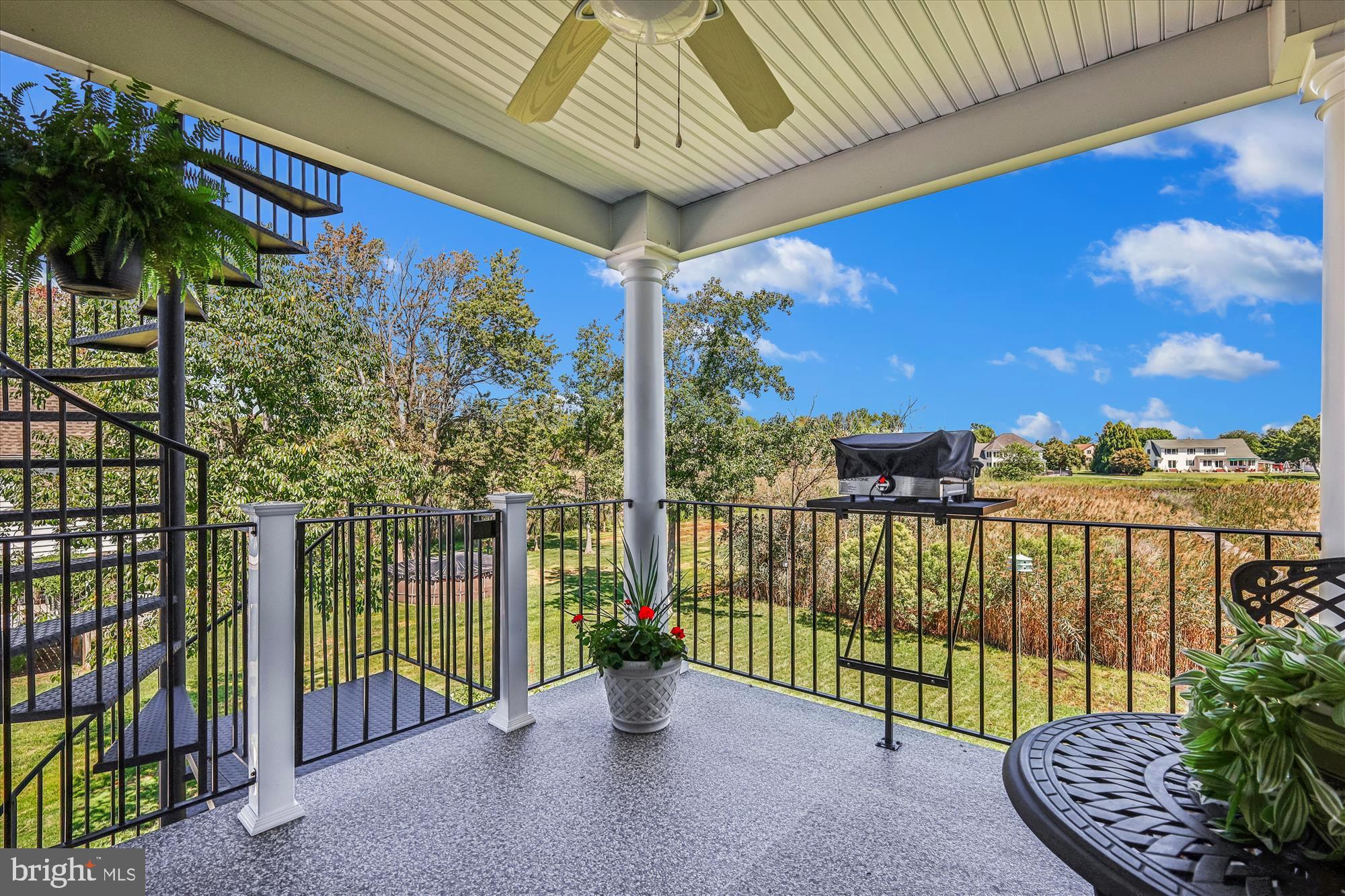 635 Dominion Road Chester, MD 21619 - Photo 46 of 50 a view of a porch with a floor to ceiling window and wooden fence