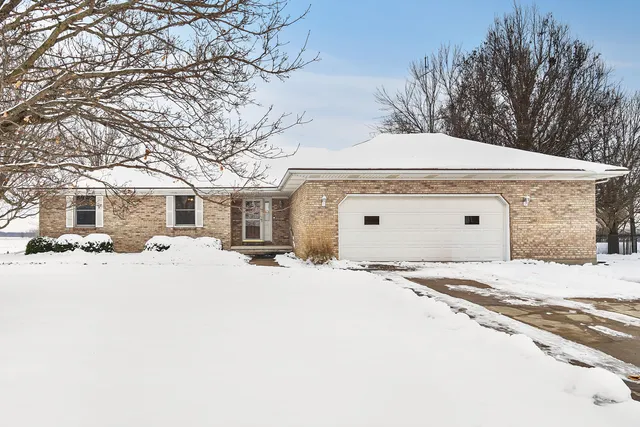 a front view of a house with a snow in front of it