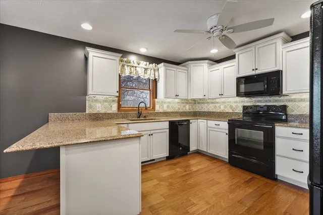 a kitchen with a stove a sink and a microwave