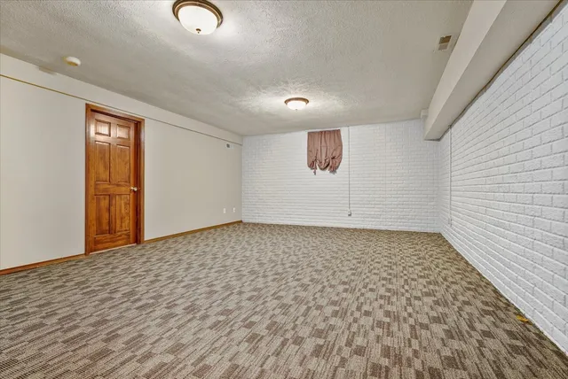 a view of a room with wooden floor and white walls