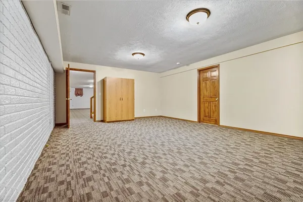a view of a room with a wooden floor