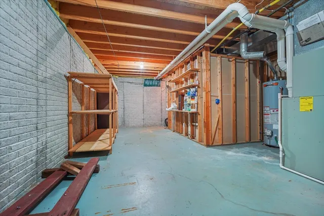 a view of an empty room with wooden floor and windows