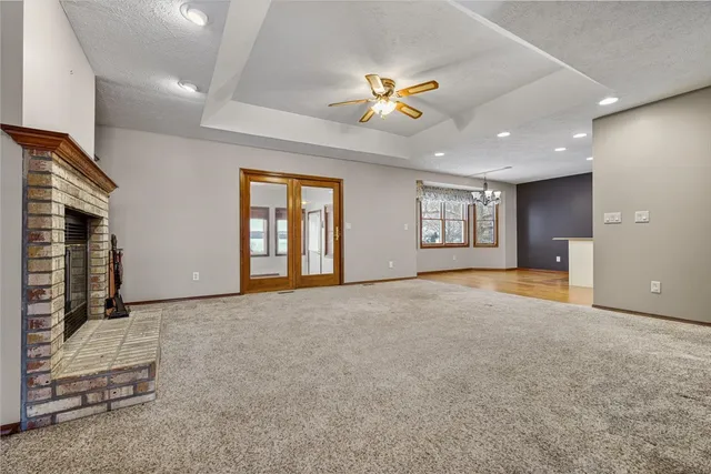 a view of an empty room with window and cabinet