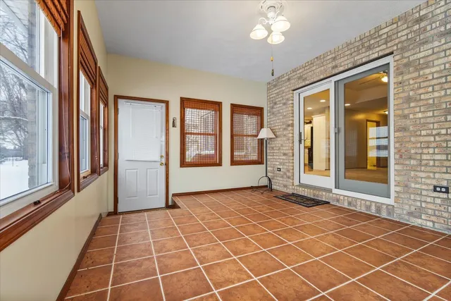 an empty room with entrance and windows