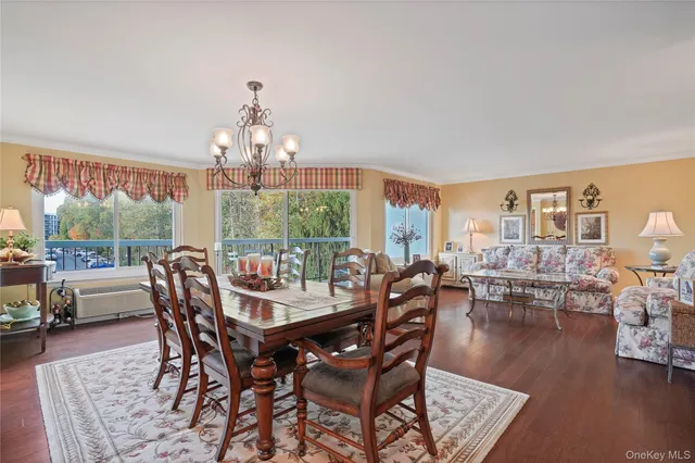 a view of a dining room with furniture wooden floor and chandelier