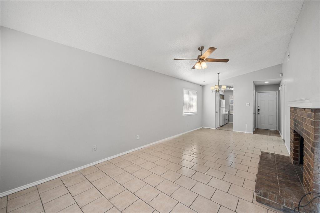 5821 Mansfield Road Arlington, TX 76017 - Photo 14 of 24 a view of a livingroom with a ceiling fan and window