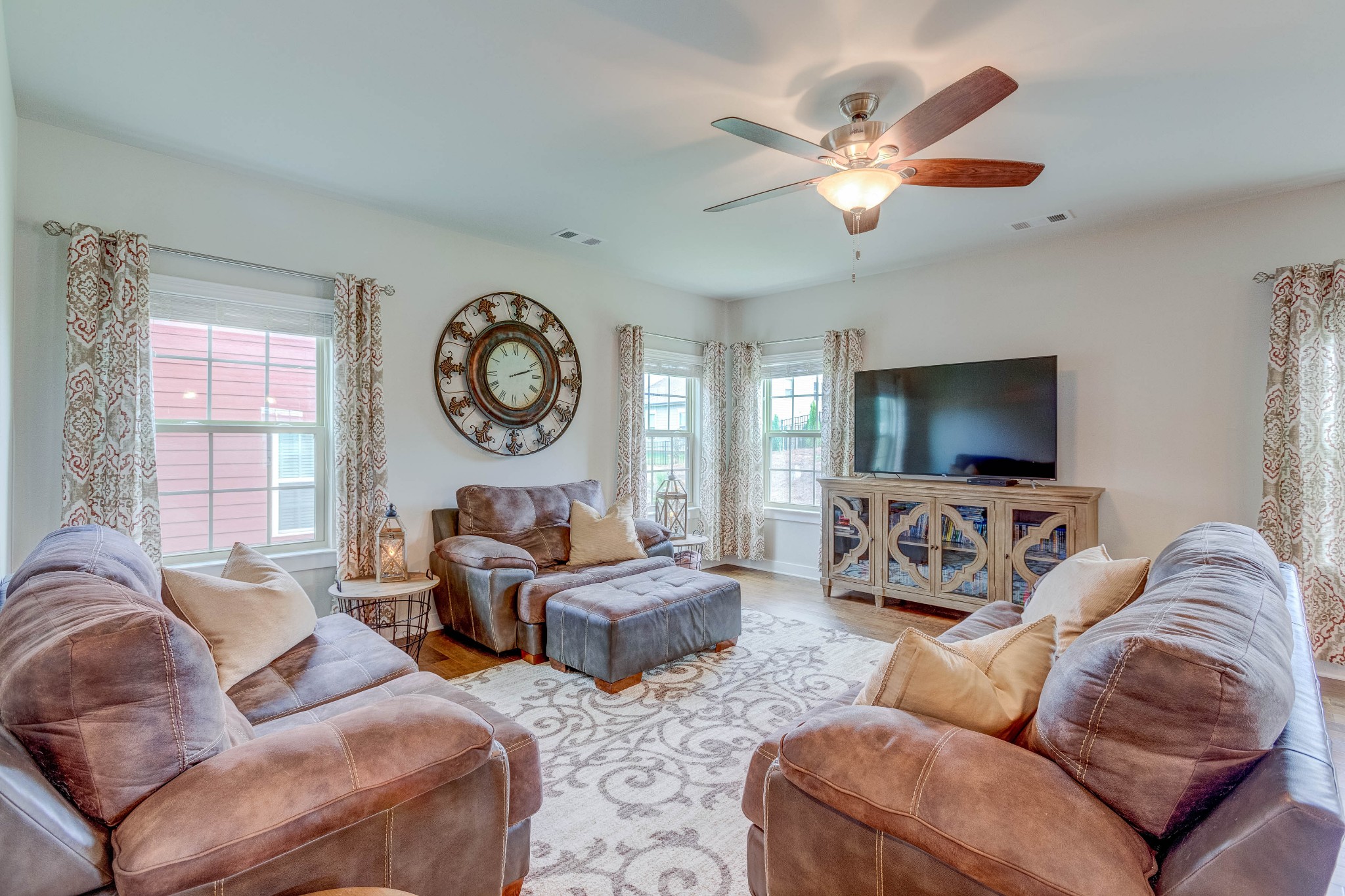 315 Collier Road Mount Juliet, TN 37122 - Photo 9 of 34 a living room with furniture a large window and a flat screen tv