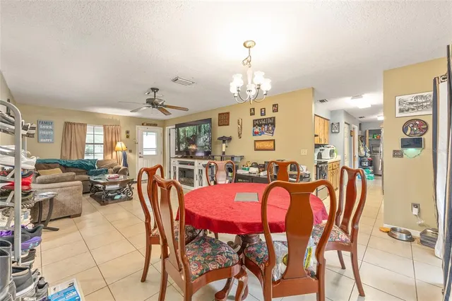 a view of a dining room with furniture and chandelier
