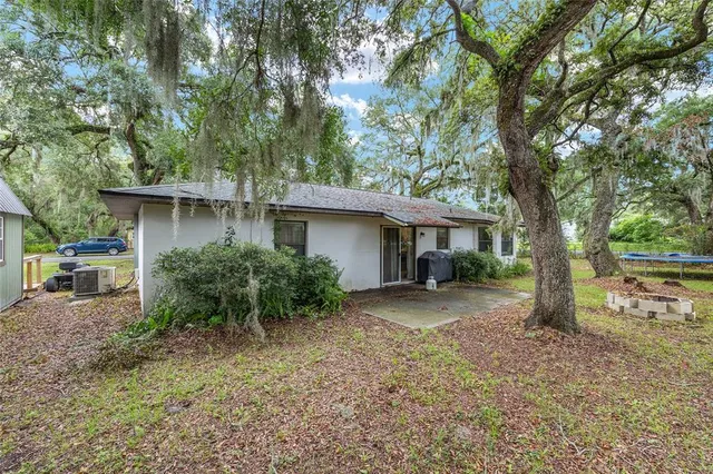 a view of a house with a tree in the yard