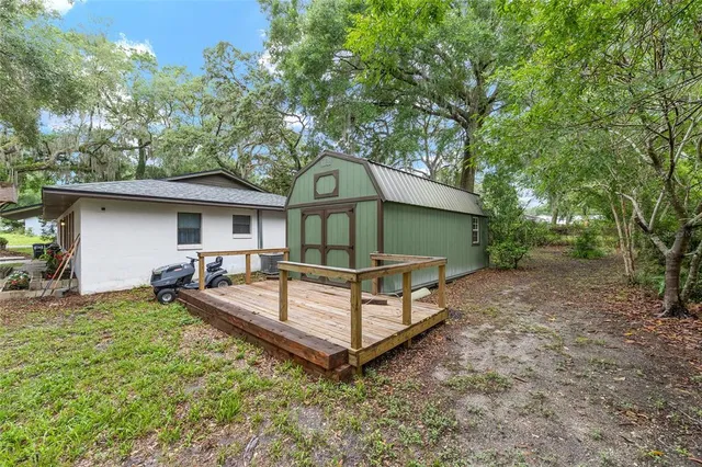 a view of a house with a yard and a patio