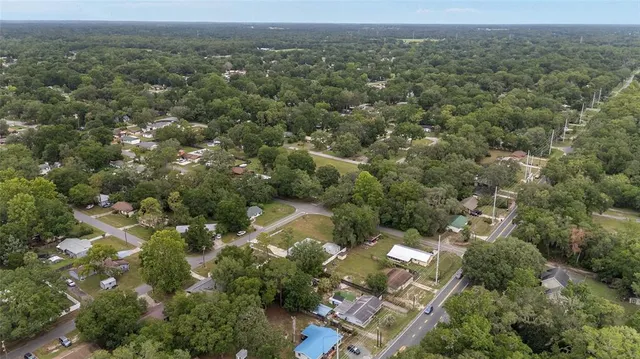 an aerial view of a house with a yard