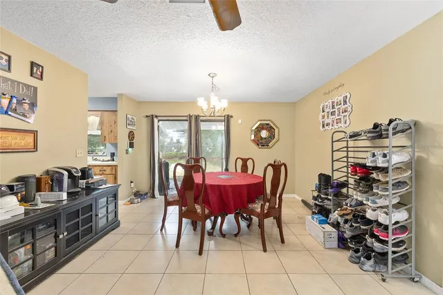 a view of a dining room with furniture and chandelier