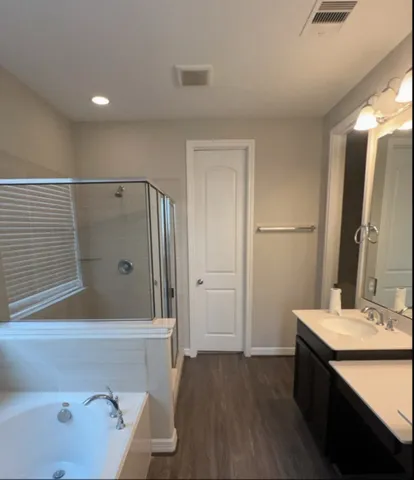 a bathroom with a bathtub and a sink