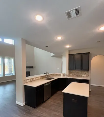 a kitchen with a sink and a stove top oven