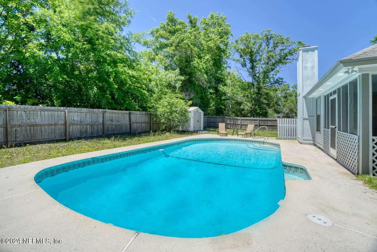 a view of a swimming pool with a backyard