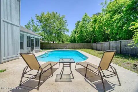 10062 Hawks Hollow Road Jacksonville, FL 32257 - Photo 2 of 39 a backyard of a house with table and chairs